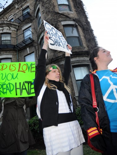 Tuesday, Dec. 1, 2009-Boston University students Julia Hershonik (left) and Emma Rosenthal (right) attended the Love Picnic outside the Florence Chafetz Hillel House Tuesday to show support for BU's LGBTQ community and oppose the anti-gay Westboro Baptist Church's protest. "The only way you can fight ridiculous people is by being ridiculous," said Hershonik. "Shrimp-this is what God really hates." | Photo by Casey Germann.