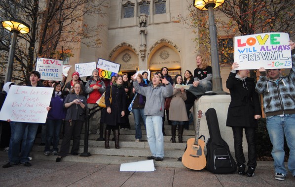 Tuesday, Dec. 1, 2009-Marsh Chapel Associate Tyler Sit encourages Boston University Students to join a group sing along on the steps of Marsh Plaza. Hundreds of BU students showed up to counter a protest by the anti-gay Westboro Baptist Church at BU's HIllel House. | Photo by Casey Germann.