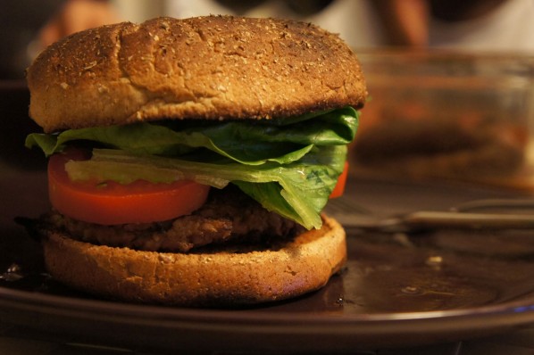 Bulgur veggie burger on a whole wheat bun with lettuce and tomato.