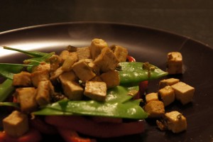 Tofu on a bed of veggies.