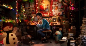 Still from 'Arthur Christmas' of Arthur, writing responses to the millions of letters he receives from children writing to Santa.