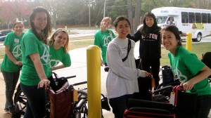 Volunteers smile while waiting in line to load wheelchairs into a delivery van. | Photo by Irene Berman-Vaporis