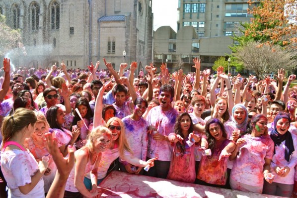 Students pose with arms raised in celebration of the Festival of Colors. | Photo courtesy of the BU Hindu Students Council