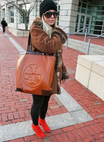 Alexandra Paradise, (COM ’15) rocks statement orange-red suede Dolce Vita booties and a cozy coat from Jones’ New York. Her Tory Burch tote allows for some style while hauling around multiple textbooks. Photo by Asta Thrastardottir.