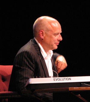 Brian Eno, photographed during a conversation with Will Wright at The Long Now Foundation in 2006. | Image courtesy Wikimedia Commons via user aomarks
