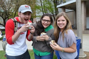 Happy students pose with their free Chipotle burritos | Photo by Alene Bouranova