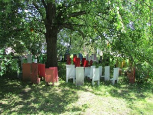 Gail Bos' "Children's Chair Project" places a cluster of miniature chairs around a large tree to represent diversity and our need to prepare our children for the future | Photo courtesy of Energy Necklace Project